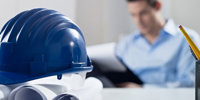 A hard hat and a worker representing Hemisphere Consulting's Quality Management